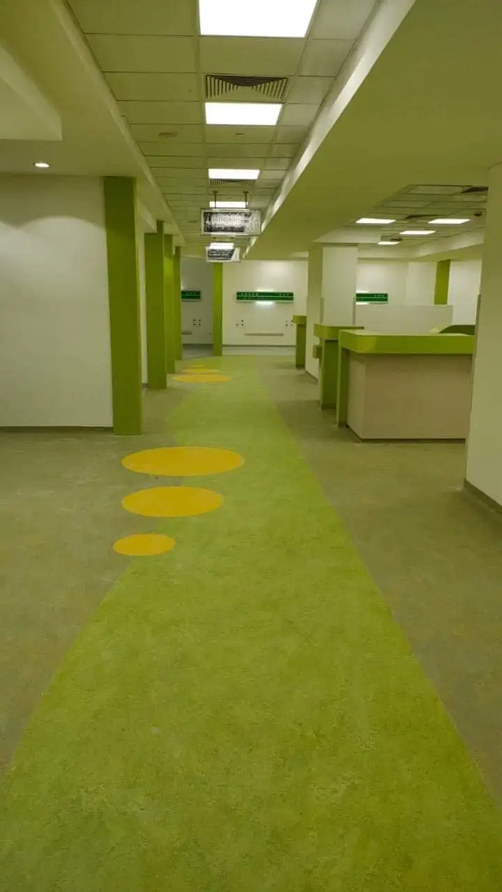 Green vinyl floor along a hospital ward corridor