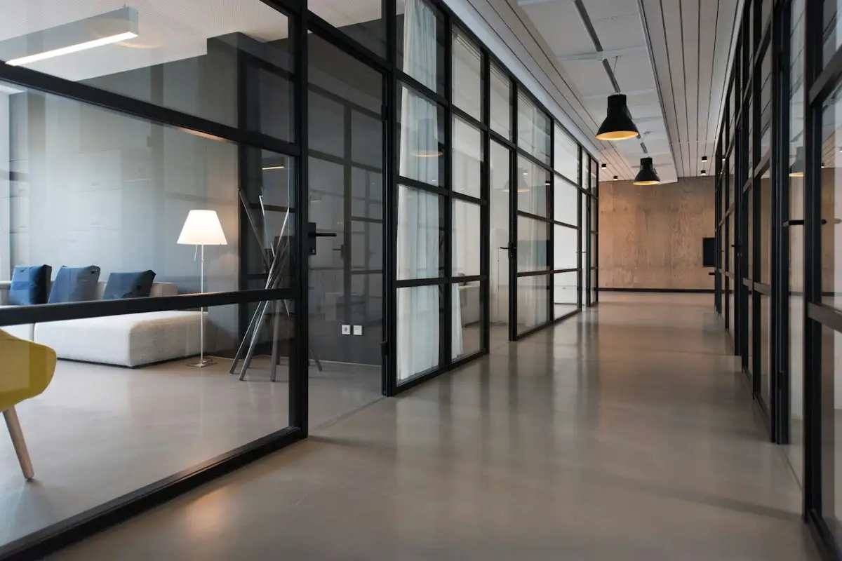 Black-framed glass partitions in an office corridor